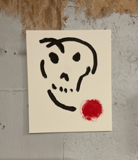 Image of skull with red dot