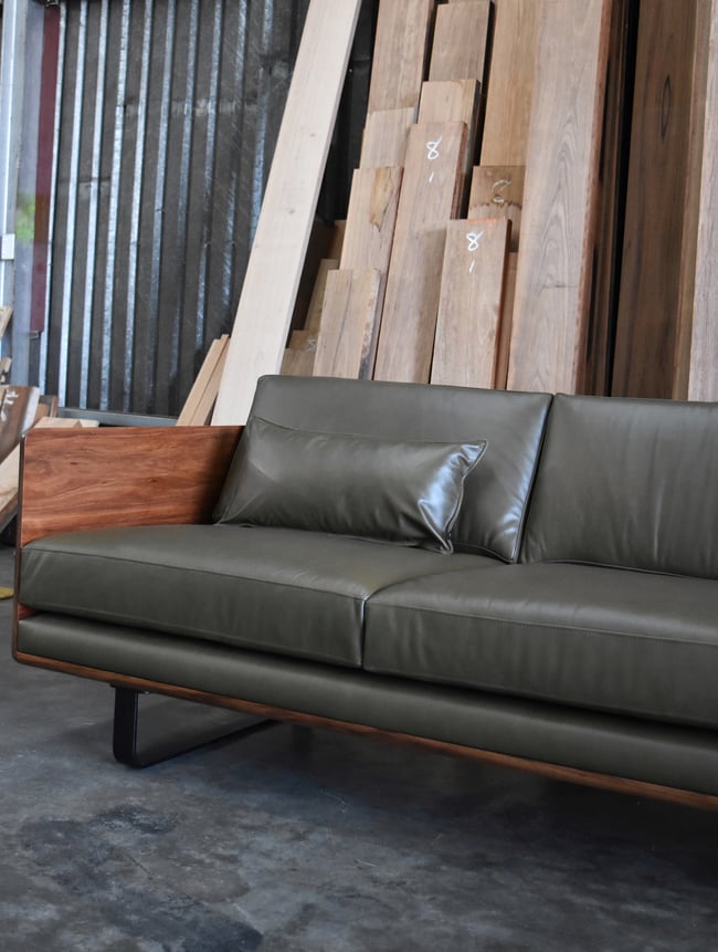 CLOVER COUCH IN TASMANIAN BLACKWOOD WITH SUNDANCE LEATHER