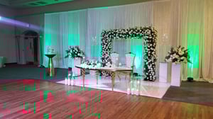 Image of Stage design with green  and white silk  flowers  