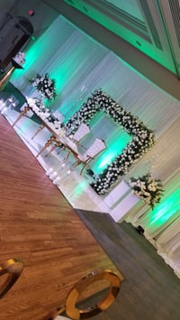 Image 4 of Stage design with green  and white silk  flowers  