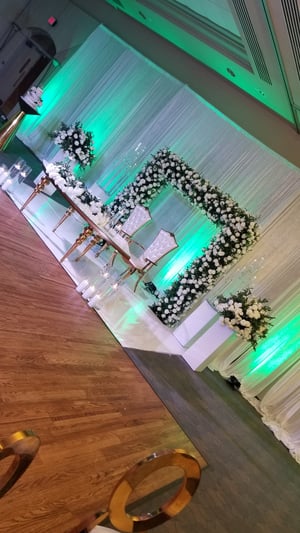 Image of Stage design with green  and white silk  flowers  