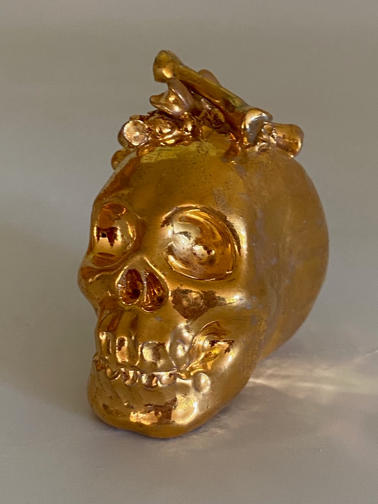 Image of Golden skull with bones detail