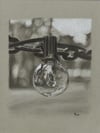 Hanging Light - White and black charcoal on grey paper