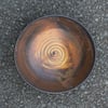 Shallow stoneware bowl with  iron-saturated glaze