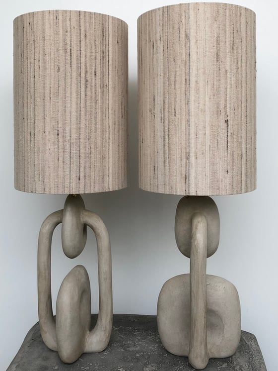 Image of handshaped light colored concrete tablelamps (2x)
