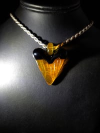 Image 2 of Orange/ black great white shark tooth pendant. 