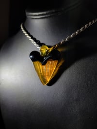 Image 3 of Orange/ black great white shark tooth pendant. 