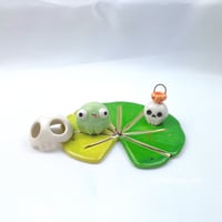 Image 1 of Frog on lily pad with skull mask and pumpkin skull lantern ceramic figurine