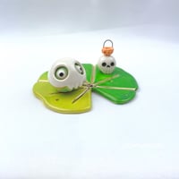 Image 4 of Frog on lily pad with skull mask and pumpkin skull lantern ceramic figurine