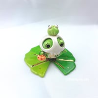 Image 3 of Zombie frog on lily pad with skull mask and pumpkin lantern ceramic figurine