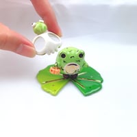 Image 1 of Zombie frog on lily pad with skull mask and pumpkin lantern ceramic figurine