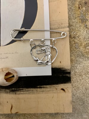 Image of "It doesn't go away, it just gets smaller" recycled silver pin