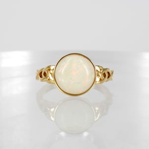 Image of 18ct yellow gold celtic style opal dress ring.