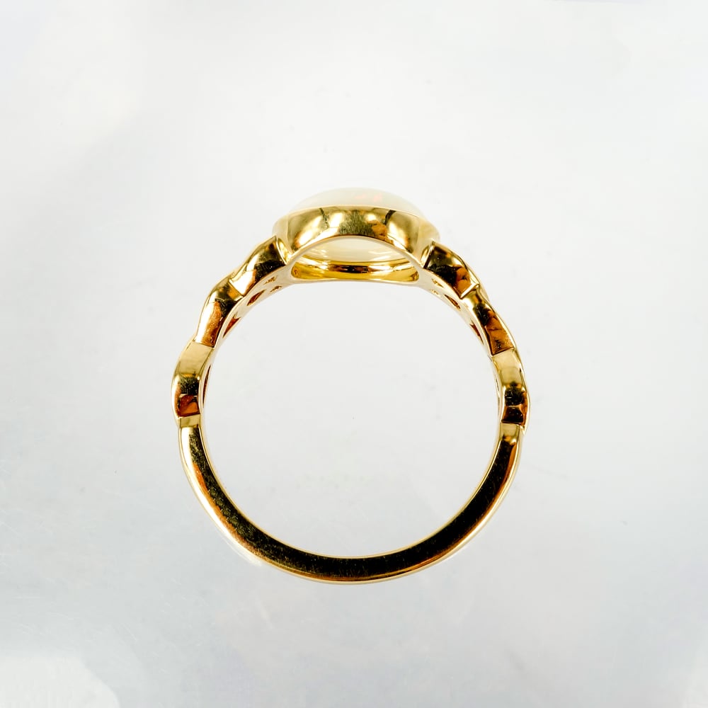 Image of 18ct yellow gold celtic style opal dress ring.
