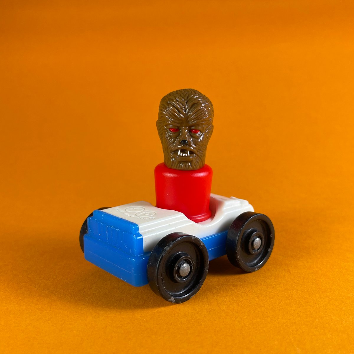 Image of Wolf man peg toy and Fisher-Price car
