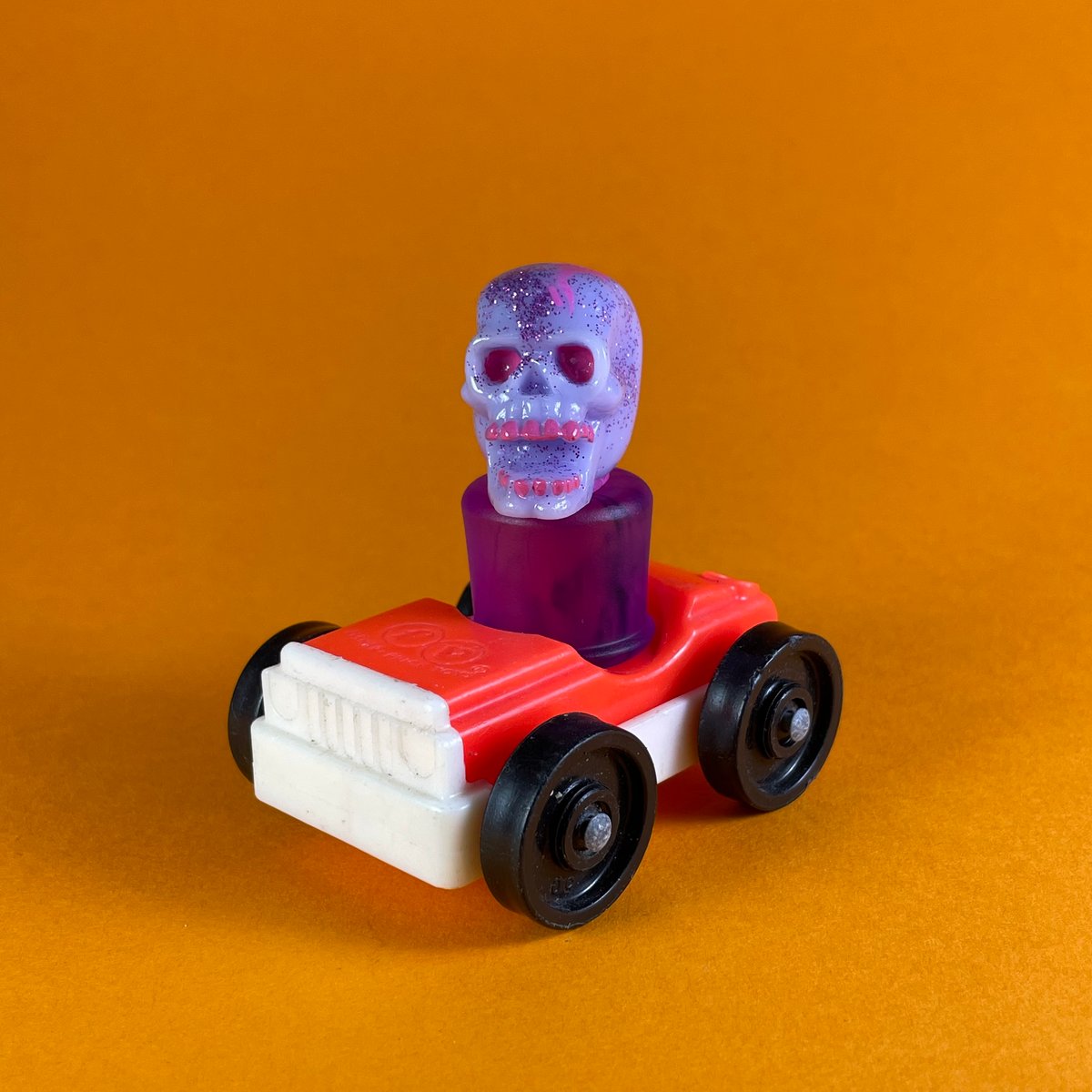 Image of Skull peg toy and Fisher-Price car