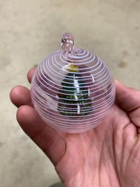 Image of Tree in an ornament with pink and white spiral 