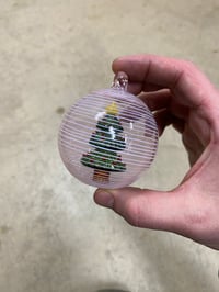 Image of Tree in an ornament with pink and white spiral 