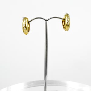 Image of 9ct yellow gold diamond set huggie earrings. SH5