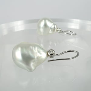Image of 18ct white gold baroque pearl and diamond drop earrings. CP1147 PJ5530