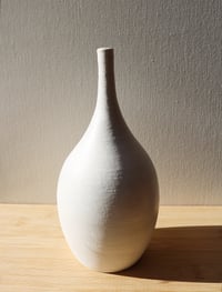 Image 1 of matte white textured thin neck vase
