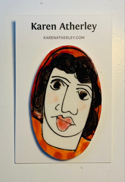 Image of Orange and red face brooch