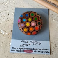 Image of round pencil brooch