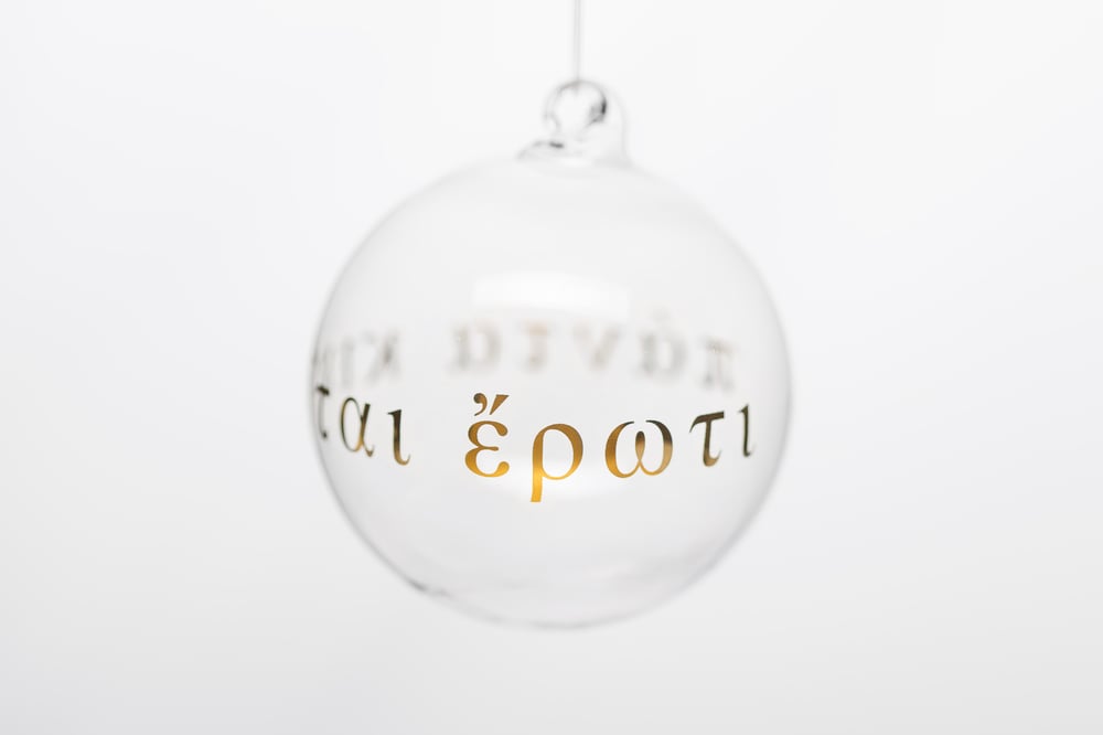 Image of "All is powered by love" 8cm Christmas tree ball with gold inscription in Ancient Greek