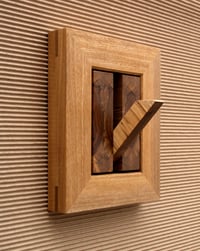 Wood wall hook with decorative frame.