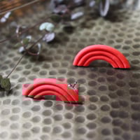 Image 1 of red arched studs