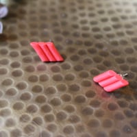 Image 3 of red arched studs