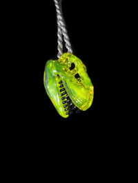 Image 2 of Mini yellow opal T-rex skull pendant. 