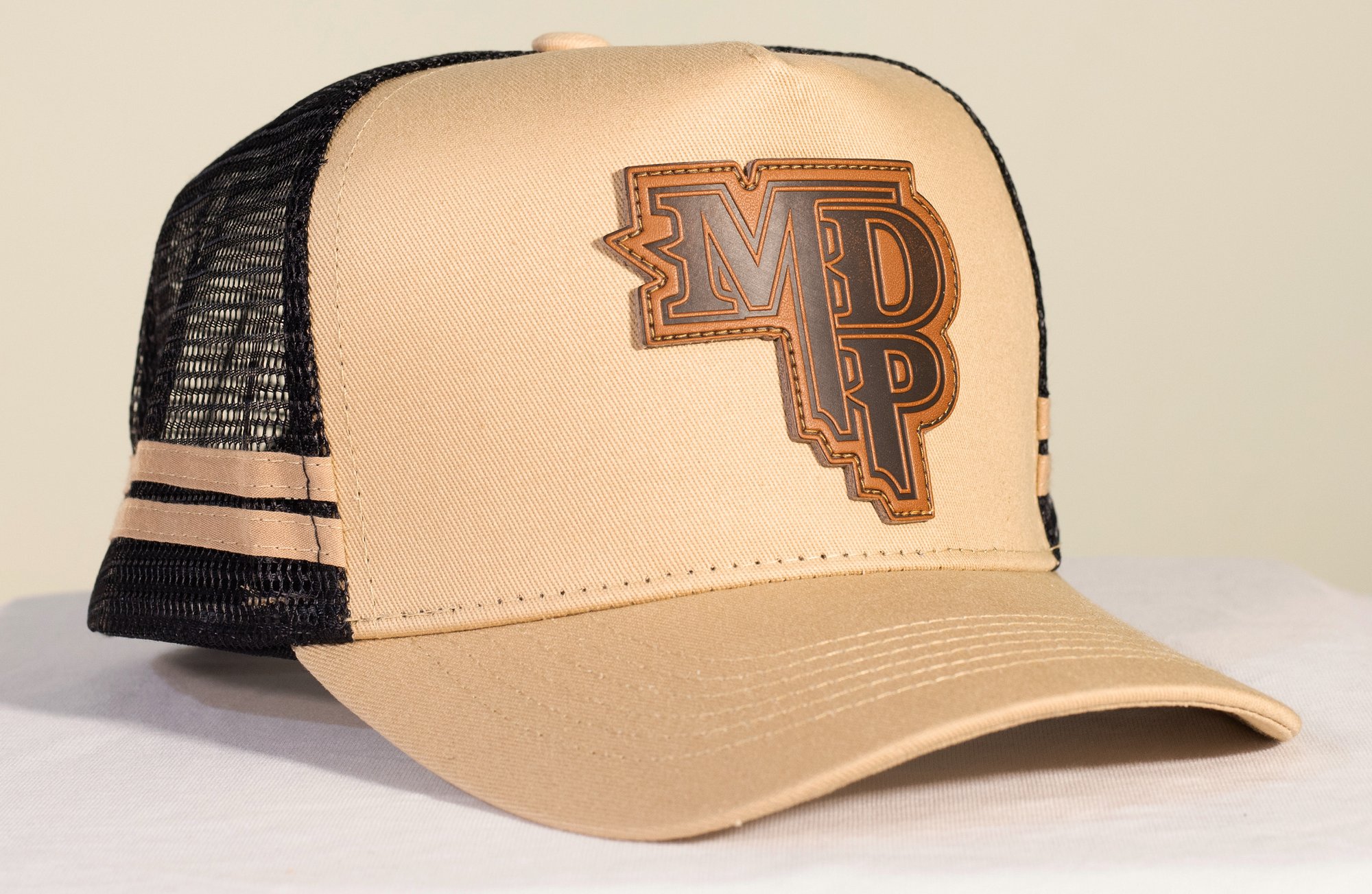Cooter’s Keep It Between The Ditches Leather Patch Trucker Hat Khaki/Coffee