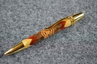 Image 1 of Segmented Wood Pen with Herringbone 360 Design that Features a Redheart and Maple Celtic Knot  #0600