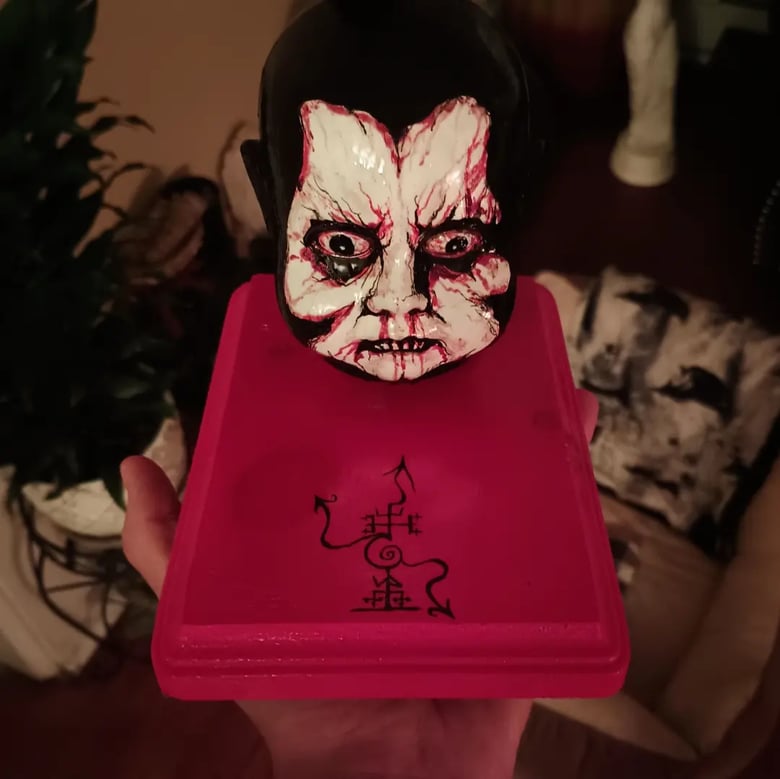 Image of Pazuzu head statue done with blood and acrylic 