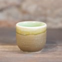 Small ceramic cup with green interior