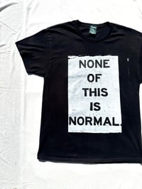Image of none of this is normal tee in black 