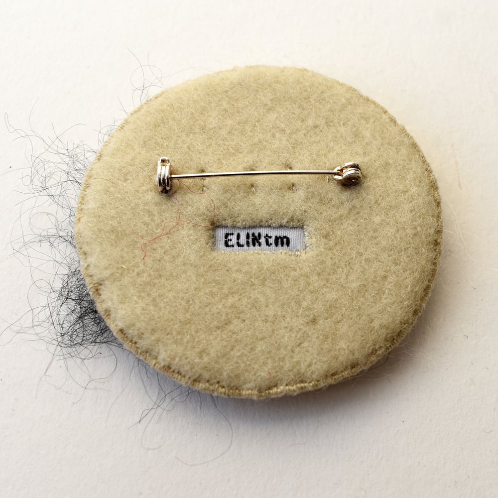 Image of Small felt brooch with embroidered moulds
