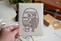 Image 1 of blank greeting card: cozy cafe