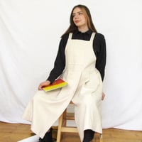 Image 1 of Split Leg Pleated Pinafore Apron with Adjustable Crossback Straps. No25 Undyed Canvas