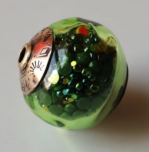 Irridescent Iguana Party Ball - a glass and red brass bead stuffed with stuff