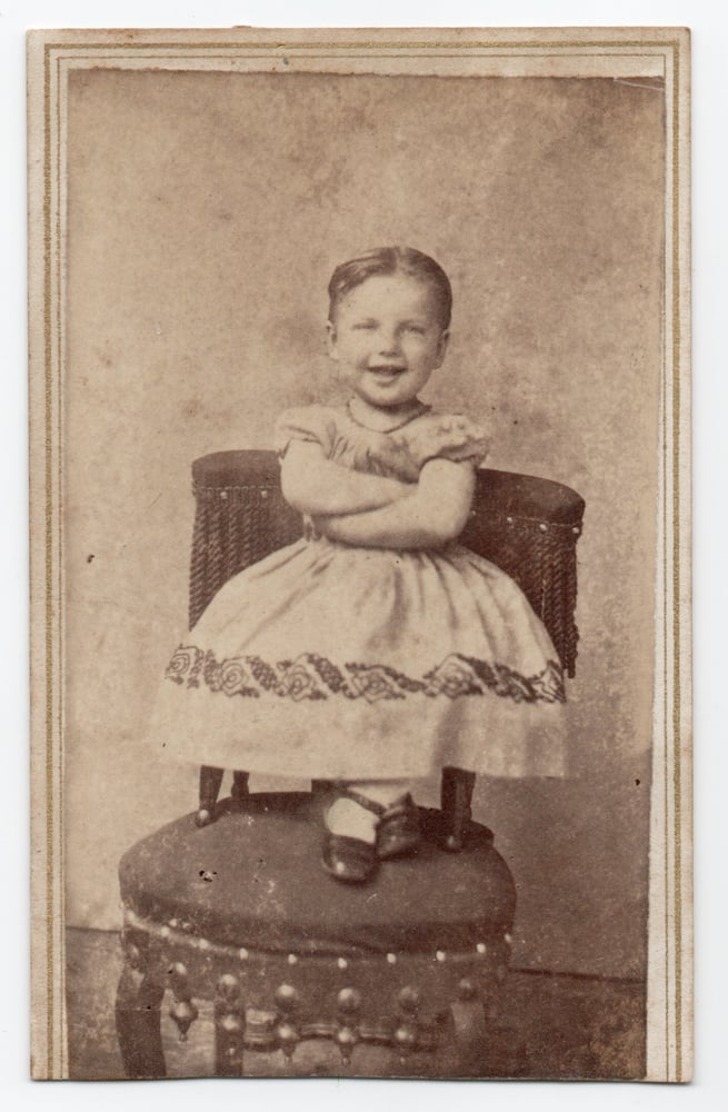 Image of Herbert Knox: smiling child with arms crossed, ca. 1865