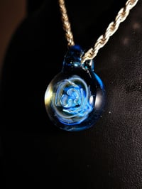 Image 3 of Uv reactive Blue rose pendant backed with blue stardust.