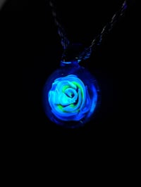 Image 4 of Uv reactive Blue rose pendant backed with blue stardust.