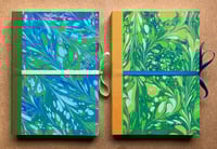 Image 3 of Sky Blue, Pale Blue & Green Hand-Marbled Large Plain Notebook- Imbolc/Snowdrop Pattern