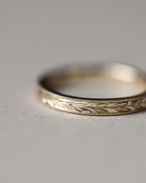 Image of 18ct Yellow gold, 2.5mm flat court Olive leaf and milled edge engraved ring