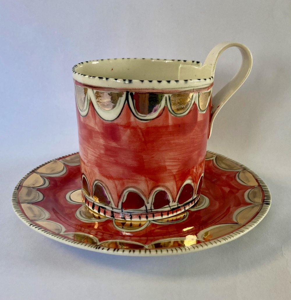 Image of Pink and gold cup and saucer