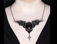 Image 2 of bat necklace from HAXANS, ALL THE ROSES music video 