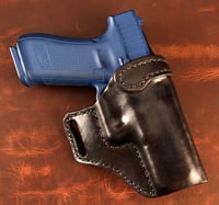 Image 1 of Glock G17 Blacked out avenger style holster.