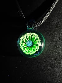 Image 4 of UV reactive glow flower pendant backed in blue stardust 💎🟢🌻